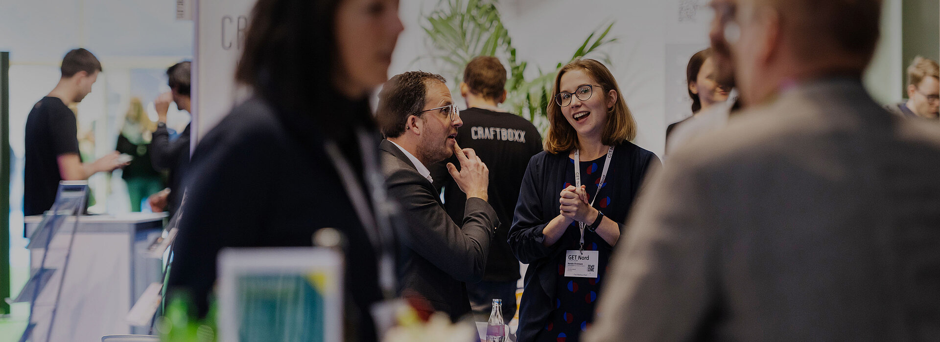 Visitors chat in a good mood at a booth at GET NORD