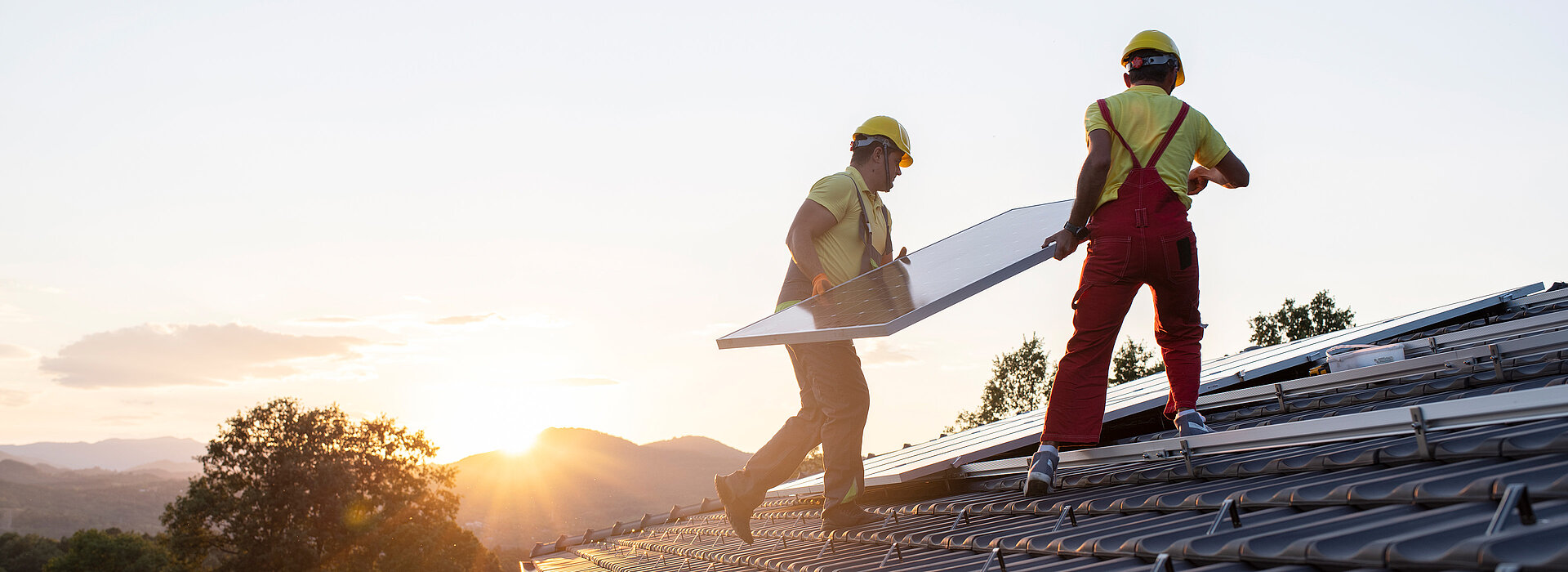 men working on a roof with solar panels